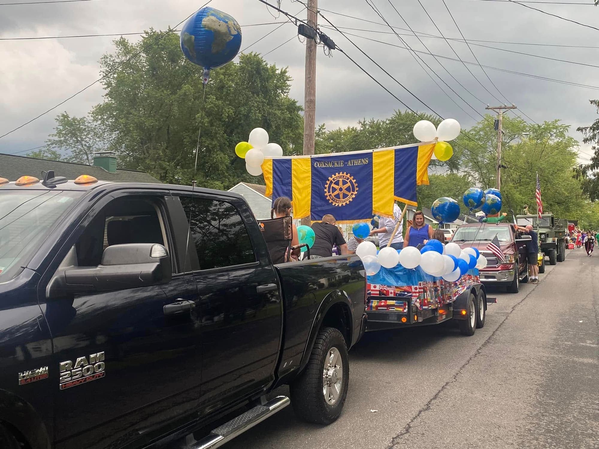 The Coxsackie-Athens Rotary parade float, hung with the club banner and decorated with globe balloons and international flags.